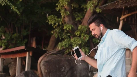Young handsome man is dancing at the beach. Stock Footage 99892427