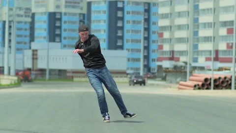 Young handsome man dancing hip hop outdoors in the city. Slow motion Stock Footage 138808612