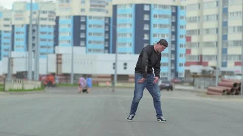 Young handsome man dancing hip hop outdoors in the city. Slow motion Stock Footage 138808624