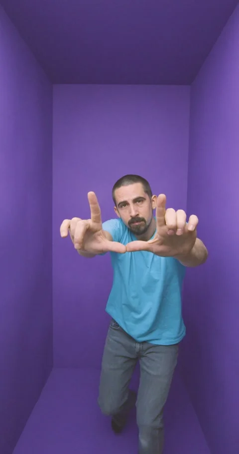 Young handsome man doing frame using hands palms and fingers, over purple Stock-Footage 266911907