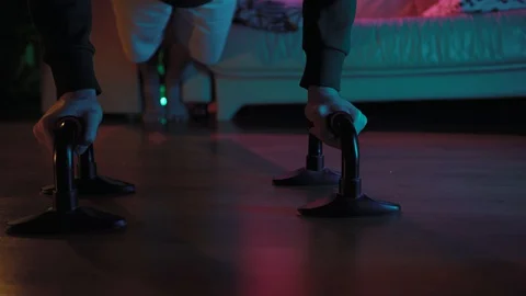 A young handsome man is doing push-UPS in a room and doing sports Stockbeeldmateriaal 128462363