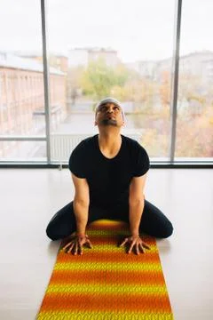 Young handsome man doing yoga meditation indoors Stock Photos
