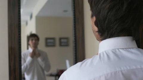 Young handsome man dressing himself in front of mirror. Stock Footage 125074035