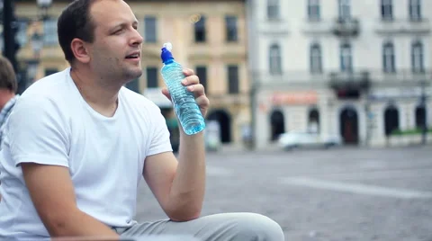 Young handsome man drinking water Stock Footage 6745949