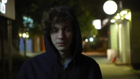 Young handsome man drinks tea on the street at night, 4k 4 Stock Footage 95725423