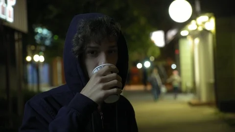 Young handsome man drinks tea on the street at night, 4k 2 動画素材 95725461