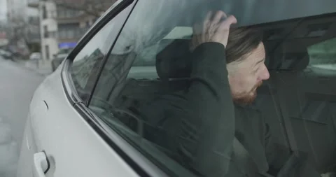 Young handsome man fixing his hair in the car Stock Footage 191047026