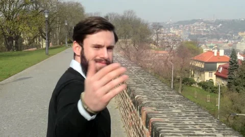Young handsome man with full-beard (hipster) walking and invites (gesture-hands) Stock-Footage 49763700