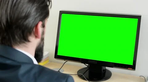 Young handsome man with full-beard (hipster)works on desktop computer in office Vídeo Stock 49848386