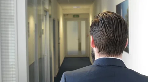 Young handsome man with full-beard (hipster) walks in the office - steadicam Stock Footage 49849800