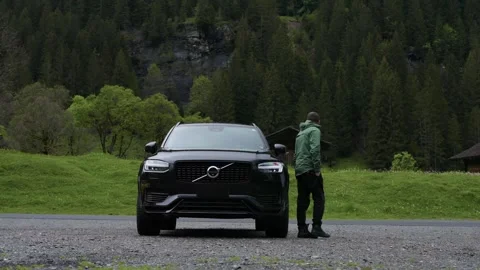 Young handsome man getting inside  SUV Volvo sport car in slow-motion Stock Footage 301548989