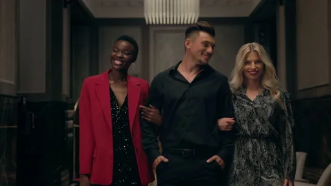 Young Handsome Man Goes With Two Women. They Go In Hotel. Man Smiles And Looks Stock Footage 161274738