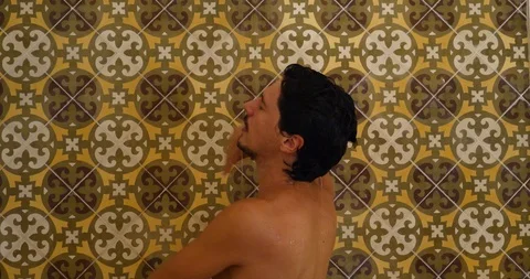 Young Handsome Man having a shower In luxury bathroom Stock Footage 120218707