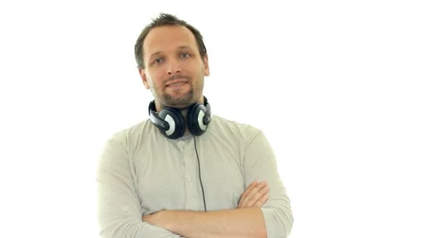 Young handsome man with headphones on his neck, isolated on white HD Stock Footage 8553053