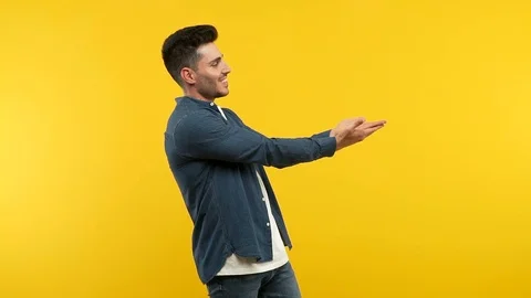 Young handsome man holding something with hands Stock Footage 97698615