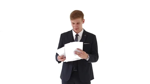 A young, handsome man in a jacket checks documents, payments, a report Stock Footage 134322931