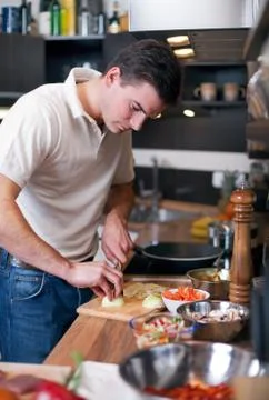 Young handsome man in kitchen Stock Photos