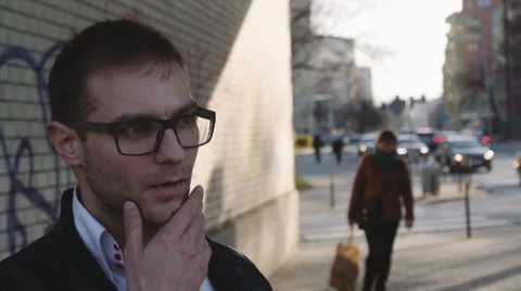 Young handsome man looking around in the city street, lost orientation. Stockbeeldmateriaal 49526354