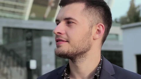 Young, handsome man looking at the camera and smiling.. Businessman standing on Stock-Footage 54685161