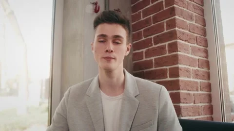 Young handsome man looking at camera, talking to friends. Motivated male job Stock Footage 141611780