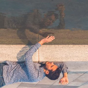 Young handsome man looking at himself in the water Stock Photos