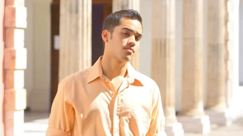 A young handsome man looks into the camera and smiles Stock Footage 33892221