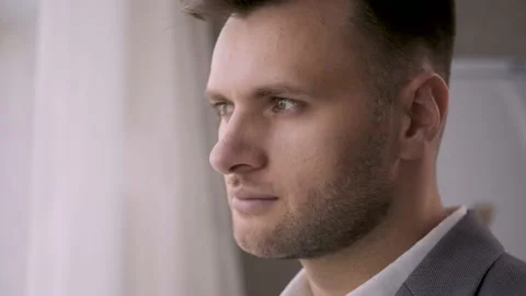 A young, handsome man looks at the camera. A guy in a classic suit Stock Footage 140995314