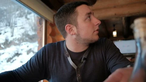 Young handsome man makes an order in a cafe or restaurant. Stock Footage 88614053