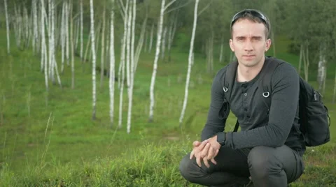 Young handsome man in a nice fitting clothes removes and wears sunglasses. Smile Stock Footage 66577943