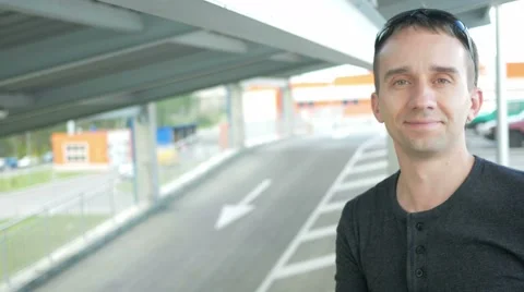 Young handsome man in a nice fitting clothes in urban landscape smile in camera Stock Footage 66578254