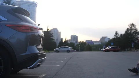 Young handsome man opens trunk put backpack and close it. Automatic system Stock-Footage 122801399