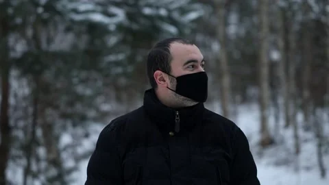 Young handsome man in outerwear, wearing a mask Stock Footage 146447864