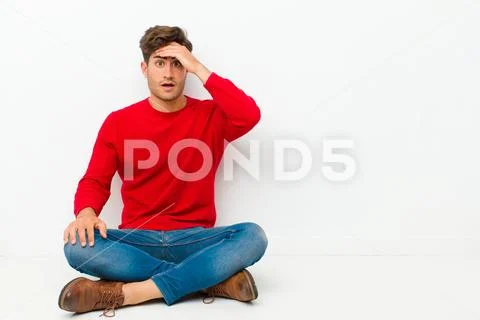 Young handsome man panicking over a forgotten deadline, feeling stressed, hav Stock Photos
