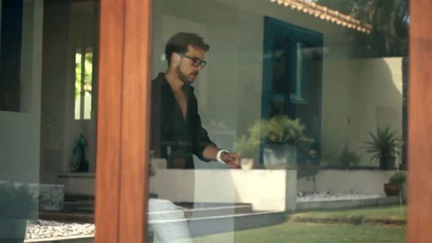 Young handsome man is picking up ond speaking on the smartphone. Video stock 85525668