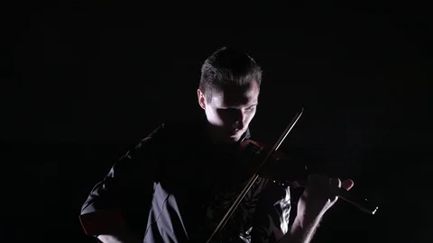 Young handsome man plays electric violin on black background, isolated Vídeo Stock 107871517