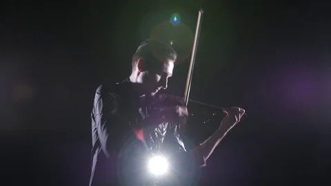 Young handsome man plays electric violin on black background, isolated 스톡 동영상 107871575