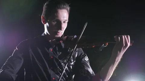 Young handsome man plays electric violin on black background, isolated 스톡 동영상 107871600