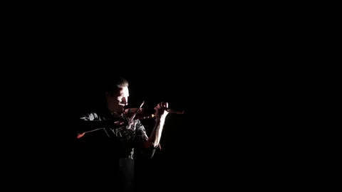 Young handsome man plays electric violin on black background, isolated 스톡 동영상 107871708