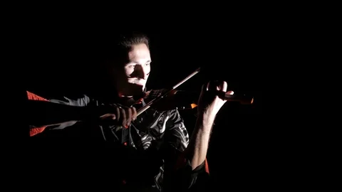 Young handsome man plays electric violin on black background, isolated Stock-Footage 107871724