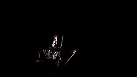 Young handsome man plays electric violin on black background, isolated Video stock 107871751