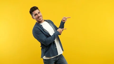 Young handsome man pointing to the side Stock Footage 97699096