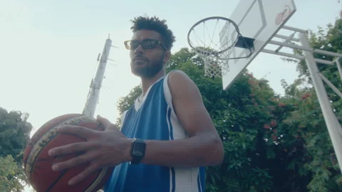 Young Handsome Man Posing with Basketball on Outdoor Court Stock Footage 239254154