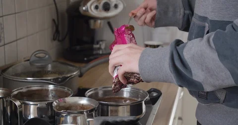 Young handsome man prepairing coffee in his kitchen, slow motion close up shot. Stock Footage 124100387