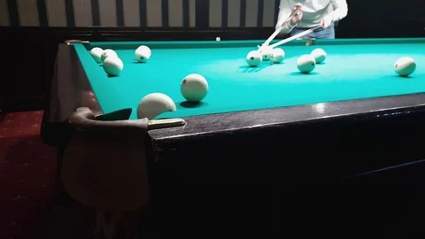 Young handsome man puts a billiard ball in the pocket 스톡 동영상 109548201