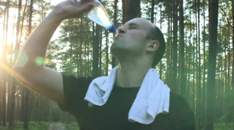 Young Handsome Man Refreshing in the Forest Stock Footage 25421004