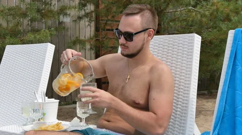 Young handsome man relaxing by the pool, Stock Footage 53312528