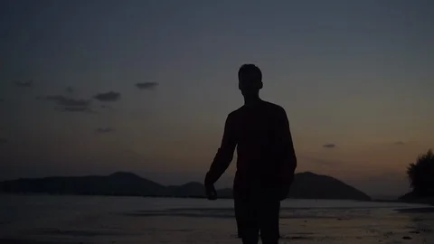 Young handsome man silhouette on the sunset celebrating success. Stock Footage 107444967