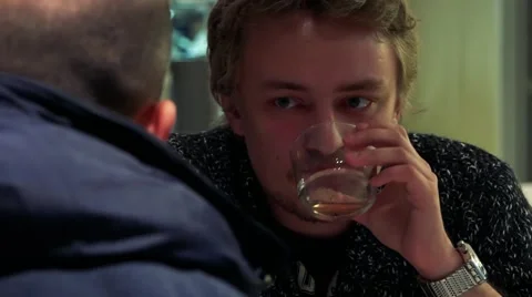 Young handsome man sit, drink and listens other people Stock-Footage 65997966