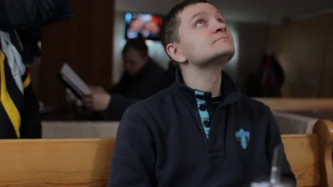 Young handsome man sitting in cafe and looking around Stock-Footage 74434437