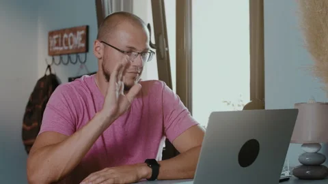 Young handsome man sitting in cafe with laptop making video Stock Footage 135117299